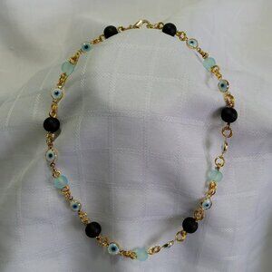 Handmade gold tone necklace with polished stones and evil eyes